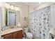 Nautical-themed bathroom featuring a shower with decorative curtain and stone countertop vanity at 8160 Sw 92Nd Cir, Ocala, FL 34481