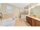 Bright bathroom with a soaking tub, double vanity, and walk-in shower at 8160 Sw 92Nd Cir, Ocala, FL 34481