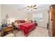 Comfortable bedroom with a double bed, ceiling fan, and bright natural light at 8160 Sw 92Nd Cir, Ocala, FL 34481