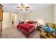 Comfortable bedroom with a double bed, ceiling fan, and ensuite bathroom access at 8160 Sw 92Nd Cir, Ocala, FL 34481