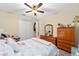 Comfortable bedroom featuring a closet, dresser, soft natural light, and flamingo-themed decor at 8160 Sw 92Nd Cir, Ocala, FL 34481