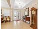 Grand Foyer with tile floors, elegant lighting, and a decorative mirror and clock at 8160 Sw 92Nd Cir, Ocala, FL 34481