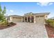 Inviting home featuring a manicured front yard, well-lit three-car garage, and welcoming entrance at 8160 Sw 92Nd Cir, Ocala, FL 34481