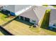 Aerial view of a well-maintained backyard featuring lush grass, a screened lanai, and a privacy fence at 4336 Nw 55Th Ct, Ocala, FL 34482