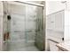 Bathroom shower with glass door, tiled walls and an accessible handrail at 4336 Nw 55Th Ct, Ocala, FL 34482