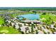 Aerial view showcasing a community with a lake, pool, golf course, and clubhouse at 4336 Nw 55Th Ct, Ocala, FL 34482