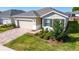 Charming home exterior with manicured landscaping, a brick driveway, and a two-car garage at 4336 Nw 55Th Ct, Ocala, FL 34482