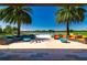 Outdoor lounge area with comfortable seating and stunning views of a lake and green landscape at 4336 Nw 55Th Ct, Ocala, FL 34482