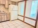 Kitchen with wood cabinets, white appliances, and light tile floor at 19728 Sw 83Rd Place Rd # A-1, Dunnellon, FL 34432