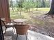 Private patio with wicker furniture and wooded views at 19728 Sw 83Rd Place Rd # A-1, Dunnellon, FL 34432