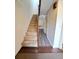 Staircase leading to upper level with wood railing at 19728 Sw 83Rd Place Rd # A-1, Dunnellon, FL 34432