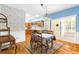 Bright dining room features hardwood floors and a view into the kitchen at 7629 Sw 188 Ave, Dunnellon, FL 34432