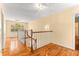 Upper hallway with hardwood floors and a staircase at 7629 Sw 188 Ave, Dunnellon, FL 34432