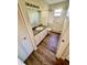 Bathroom featuring a single sink vanity and tiled shower-tub with wood look flooring at 9025 Sw 94Th Ln # C, Ocala, FL 34481