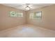 Bedroom with two large windows, a ceiling fan, and neutral carpet at 9025 Sw 94Th Ln # C, Ocala, FL 34481