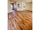 Living room featuring wood-look flooring leading to a kitchen with white cabinetry at 9025 Sw 94Th Ln # C, Ocala, FL 34481