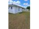 A view of the backyard of this beautiful white home with blue skies at 9951 Sw 62Nd Ter, Ocala, FL 34476