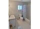 Well-lit bathroom with a toilet, shower and tub combo with a blue patterned curtain, and neutral walls at 9951 Sw 62Nd Ter, Ocala, FL 34476