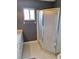 Bright bathroom featuring a glass-enclosed shower, small window, and neutral-tone walls at 9951 Sw 62Nd Ter, Ocala, FL 34476