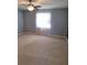 Bedroom featuring carpet, a ceiling fan, and a large window at 9951 Sw 62Nd Ter, Ocala, FL 34476