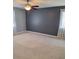 Bedroom featuring carpet, a ceiling fan, and a large window at 9951 Sw 62Nd Ter, Ocala, FL 34476