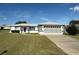 Charming single-story home featuring a well-manicured lawn and an attached two-car garage at 9951 Sw 62Nd Ter, Ocala, FL 34476