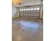 Spacious garage featuring an automatic door, offering ample room for parking and storage at 9951 Sw 62Nd Ter, Ocala, FL 34476