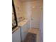 Bright laundry room featuring modern washer and dryer units with storage shelving at 9951 Sw 62Nd Ter, Ocala, FL 34476