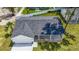 New home with gray roof, white siding, and covered patio at 13026 Ne 6 Pl, Silver Springs, FL 34488