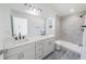 Modern bathroom with double sink vanity, tiled shower, and sleek fixtures for a luxurious feel at 13026 Ne 6 Pl, Silver Springs, FL 34488