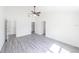Spacious bedroom with gray wood-look floors and high ceilings, offering a bright and airy atmosphere at 13026 Ne 6 Pl, Silver Springs, FL 34488