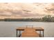 A wooden dock extending into a calm lake, perfect for relaxation and enjoying nature at 13026 Ne 6 Pl, Silver Springs, FL 34488