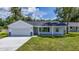Newly built home with a covered porch and a gray stone accent at 13026 Ne 6 Pl, Silver Springs, FL 34488