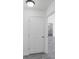 Bright hallway leading to the bathroom with modern gray floors and white walls at 13026 Ne 6 Pl, Silver Springs, FL 34488