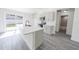 Modern kitchen with a large island, stainless steel appliances, and sliding glass doors to the backyard at 13026 Ne 6 Pl, Silver Springs, FL 34488