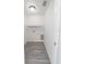 Practical laundry room with a shelf and modern gray wood-look floors at 13026 Ne 6 Pl, Silver Springs, FL 34488