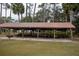 Large community picnic shelter with multiple picnic tables for outdoor gatherings and events at 13026 Ne 6 Pl, Silver Springs, FL 34488