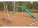 Community playground with swings, slide, and a wooden bench in a natural wooded setting at 13026 Ne 6 Pl, Silver Springs, FL 34488