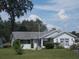 Charming single-story home featuring a well-maintained lawn, mature trees, and an attached one car garage at 612 Fannich Ct, Leesburg, FL 34788