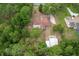 Aerial view of a residence surrounded by verdant trees at 8975 Sw 202Nd Avenue Rd, Dunnellon, FL 34431