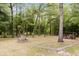 Spacious backyard with designated fire pit area and convenient firewood storage at 8975 Sw 202Nd Avenue Rd, Dunnellon, FL 34431