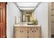 Bathroom featuring a large mirror, a vanity with storage, and a modern light fixture at 8975 Sw 202Nd Avenue Rd, Dunnellon, FL 34431