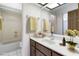 This bathroom features a sink and vanity with a full mirror and floral accents at 8975 Sw 202Nd Avenue Rd, Dunnellon, FL 34431