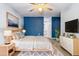 This primary bedroom offers a ceiling fan, a large dresser, and a sleek, contemporary bed frame at 8975 Sw 202Nd Avenue Rd, Dunnellon, FL 34431