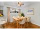 Well-lit dining room featuring a wood table, modern chairs, and wood floors at 8975 Sw 202Nd Avenue Rd, Dunnellon, FL 34431