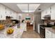 Well-lit kitchen with white cabinets, stainless steel appliances, and a granite countertop at 8975 Sw 202Nd Avenue Rd, Dunnellon, FL 34431