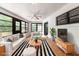 The living room is light and bright with black-framed windows and neutral décor at 8975 Sw 202Nd Avenue Rd, Dunnellon, FL 34431
