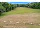 A pristine open field ready for recreational activities surrounded by beautiful mature trees at 8975 Sw 202Nd Avenue Rd, Dunnellon, FL 34431