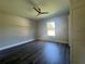 Spacious bedroom with large window, luxury vinyl plank flooring, and ceiling fan at 10325 Se 126Th St, Belleview, FL 34420