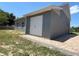 Detached garage with white double doors and paver driveway at 274 Se 34Th Pl, Ocala, FL 34471